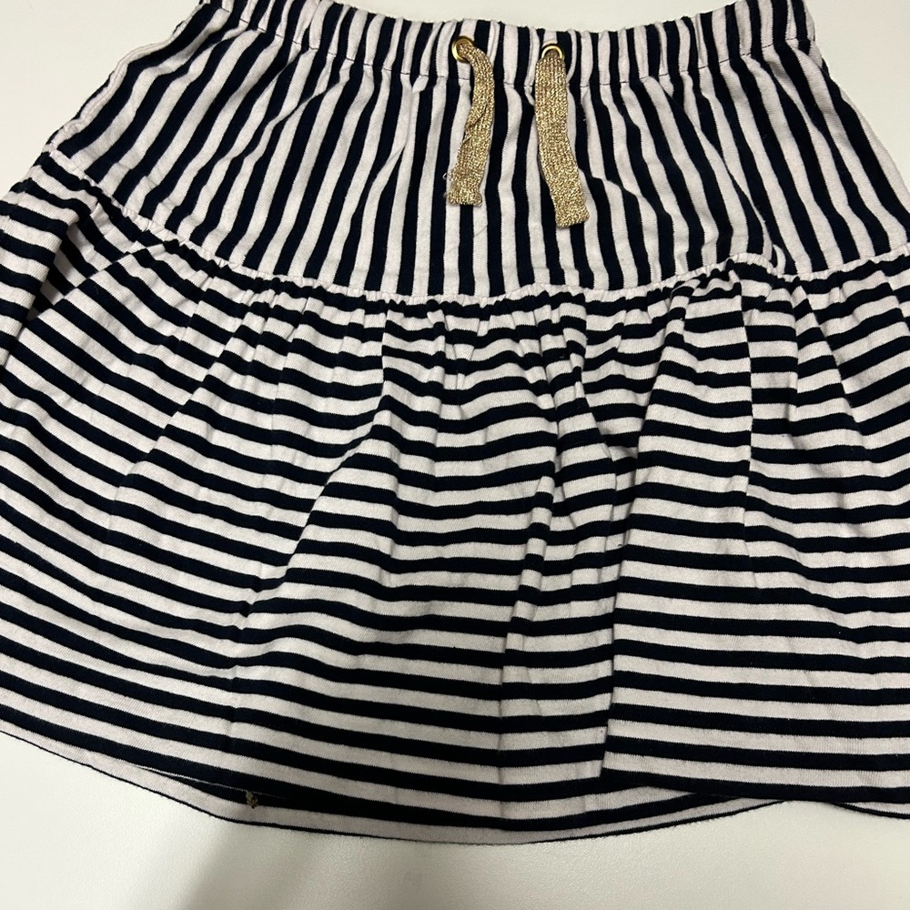 New with tags Navy blue striped skirt with gold strings that could be tied.